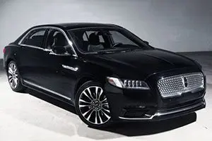The black lincoln continental is parked in a garage.