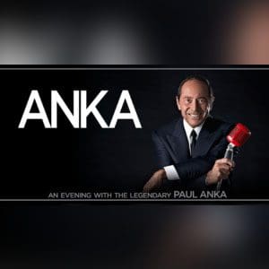 A man holding a red umbrella in front of the name anka.