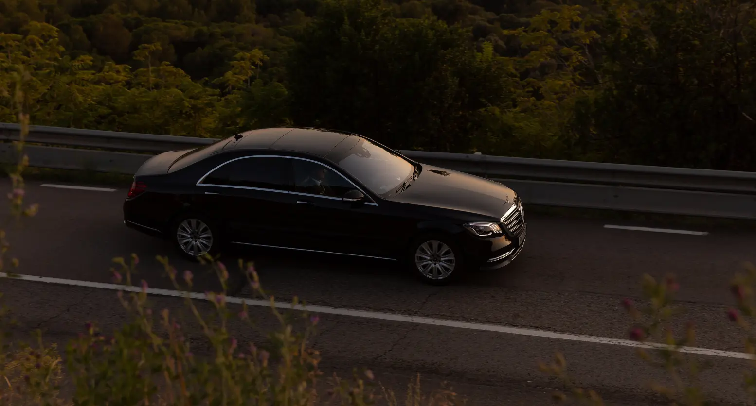 Mercedes - benz s-class driving on a mountain road.