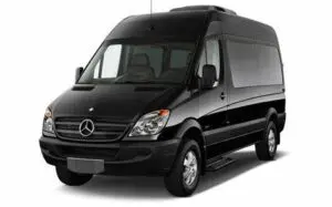 A black van is parked in front of the camera.